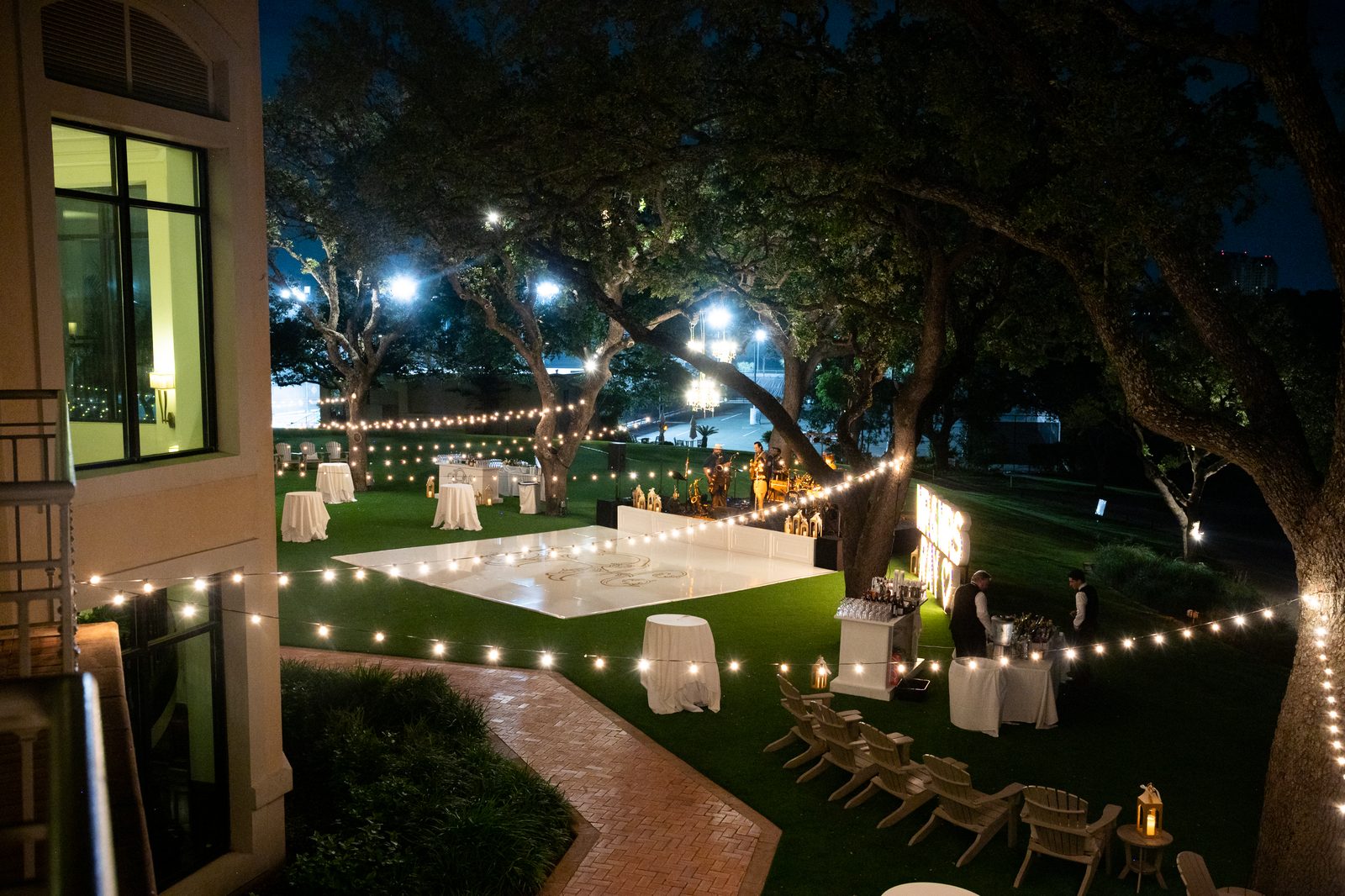 An evening reception glowing under string lights
