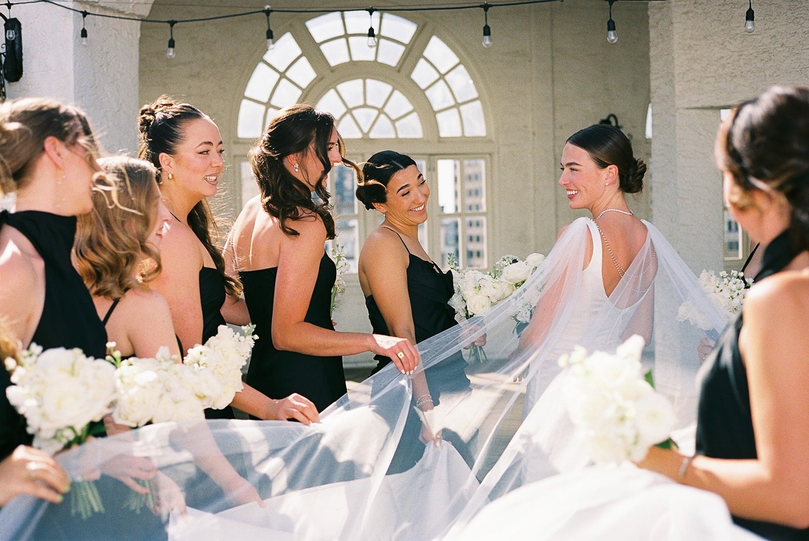 Bridesmaids helping the bride with her veil
