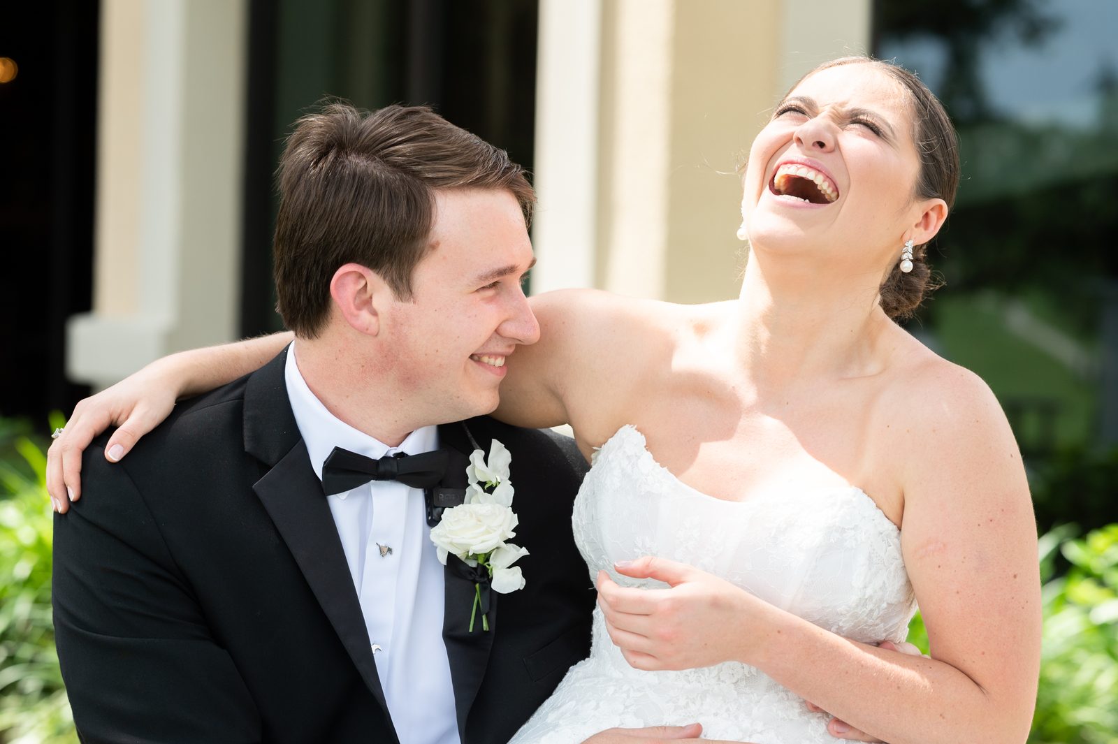A couple laughing together on their wedding day